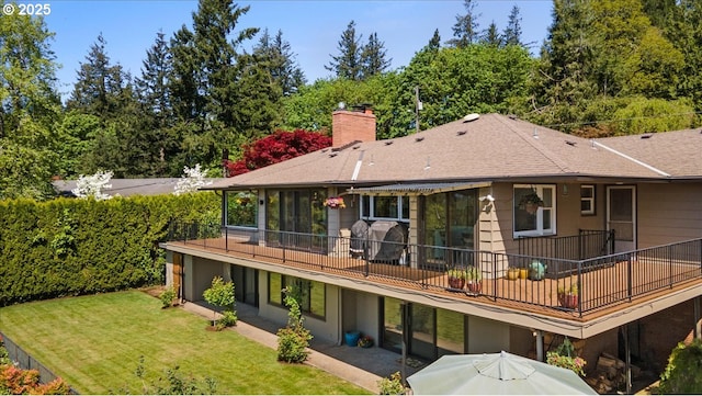 3132 SW Altadena Ter, Portland, OR 97239 - rear view of property featuring a chimney, a yard, and roof with shingles