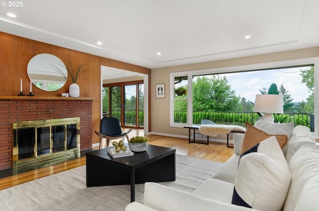 3132 SW Altadena Ter, Portland, OR 97239 - living room featuring a brick fireplace, wood finished floors, recessed lighting, and baseboards