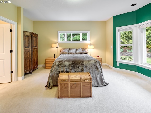 bedroom featuring light carpet