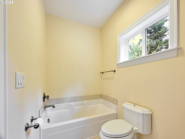 bathroom featuring a bath and toilet