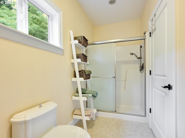 bathroom featuring toilet and walk in shower