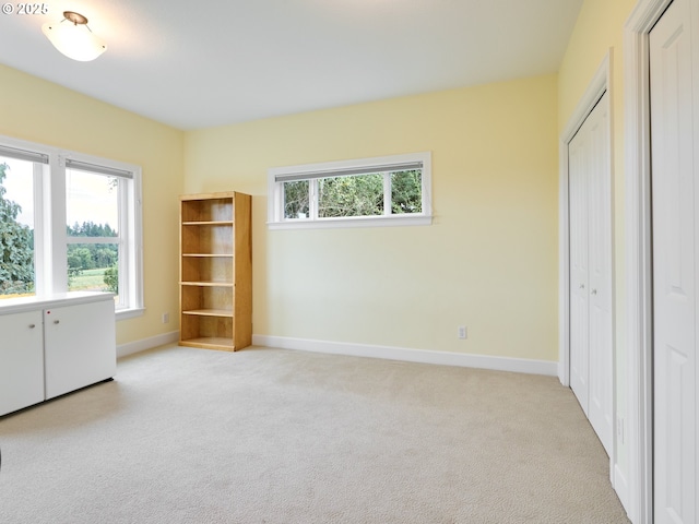 unfurnished bedroom with light carpet