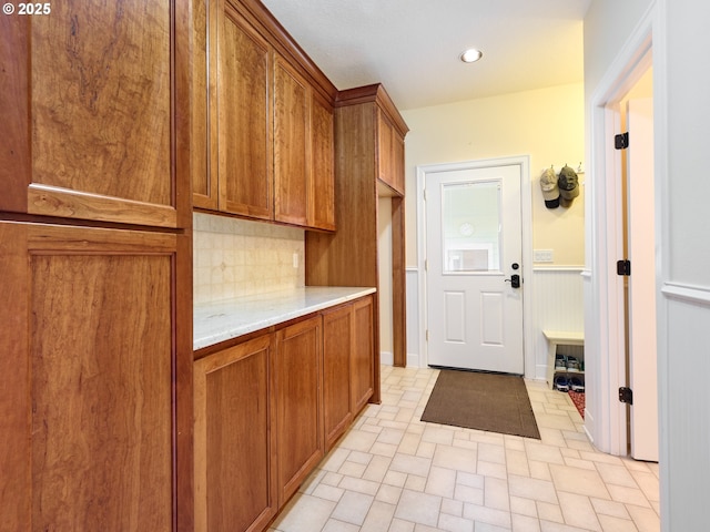 kitchen with decorative backsplash and light stone countertops