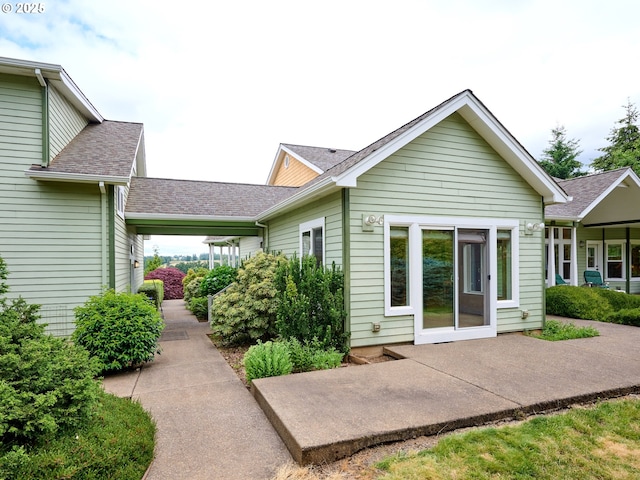 back of property with a patio