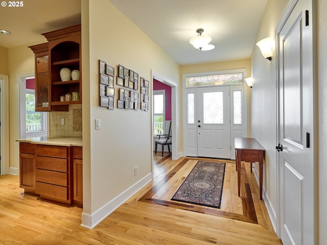 foyer entrance with light hardwood / wood-style flooring