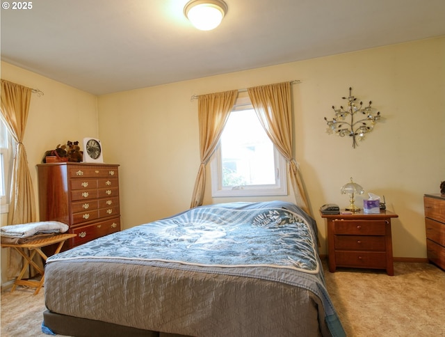 bedroom featuring light carpet