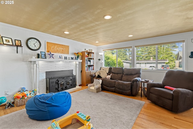 1910 Lincoln St, North Bend, OR 97459 - living room with a fireplace, wood finished floors, crown molding, and recessed lighting