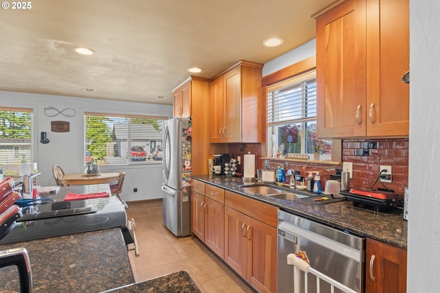1910 Lincoln St, North Bend, OR 97459 - kitchen featuring appliances with stainless steel finishes, healthy amount of natural light, decorative backsplash, light tile patterned flooring, and recessed lighting