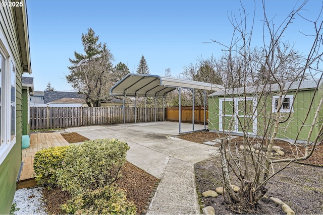 view of patio / terrace featuring a storage unit and a carport