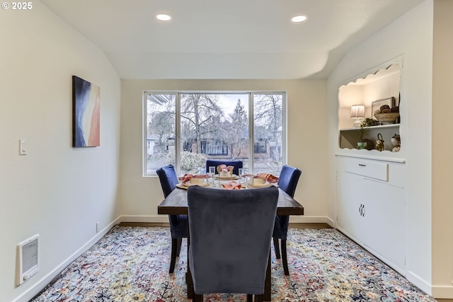 dining room featuring lofted ceiling