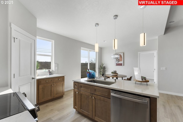 1203 NE Emerald Dr, Hermiston, OR 97838 - kitchen with dishwasher, range with electric stovetop, light wood finished floors, and an island with sink