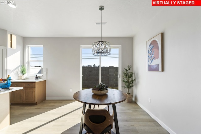 1203 NE Emerald Dr, Hermiston, OR 97838 - dining space with light wood finished floors and a chandelier
