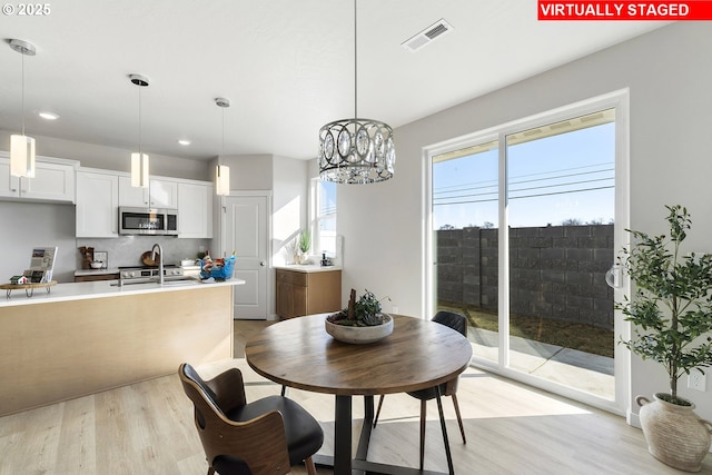 1203 NE Emerald Dr, Hermiston, OR 97838 - dining room with light wood-type flooring, recessed lighting, and a chandelier