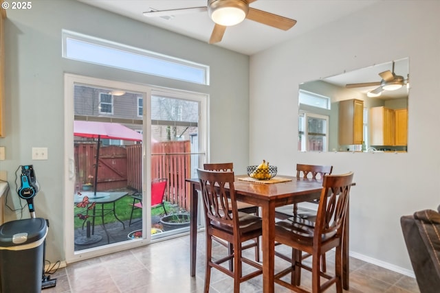 dining space featuring baseboards and a ceiling fan