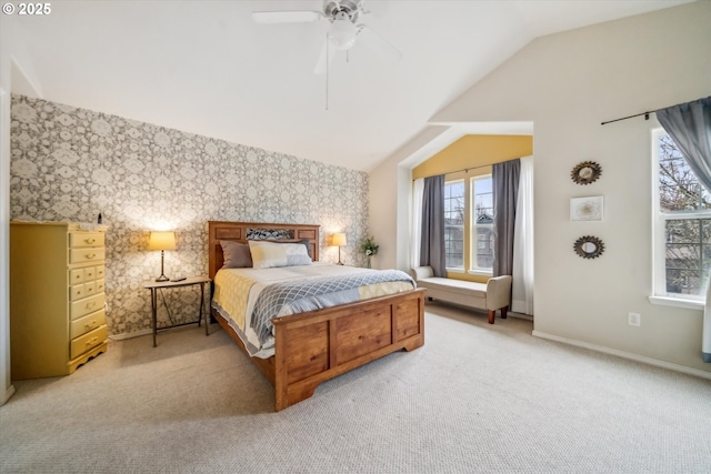 bedroom featuring a ceiling fan, light carpet, vaulted ceiling, baseboards, and wallpapered walls