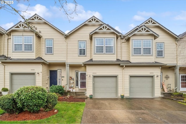 townhome / multi-family property featuring driveway and an attached garage