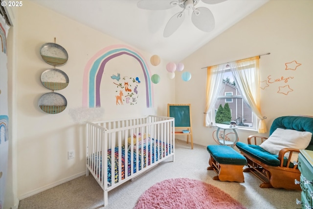 carpeted bedroom with lofted ceiling, ceiling fan, a crib, and baseboards