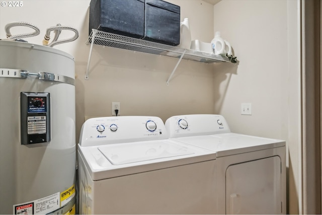 washroom with laundry area, secured water heater, and washer and clothes dryer