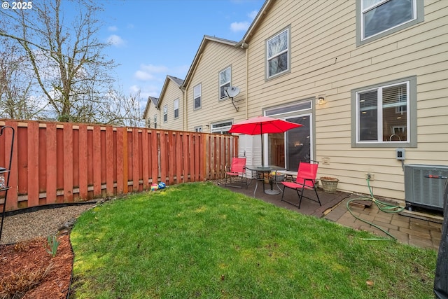 view of yard with central air condition unit, a patio area, and a fenced backyard