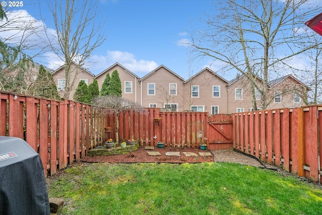 view of yard featuring a fenced backyard and a gate