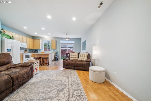 living area with ceiling fan, recessed lighting, visible vents, baseboards, and light wood finished floors