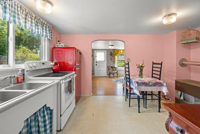4315 SE Rhodesa St, Milwaukie, OR 97222 - kitchen with white appliances, arched walkways, and light floors