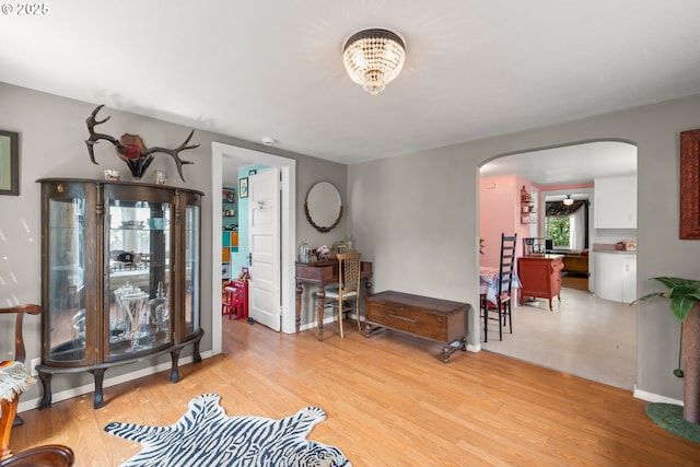 4315 SE Rhodesa St, Milwaukie, OR 97222 - living area with arched walkways, light wood-style floors, and a chandelier