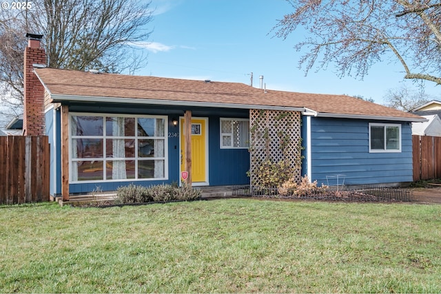 single story home featuring a shingled roof, a front yard, fence, and a chimney