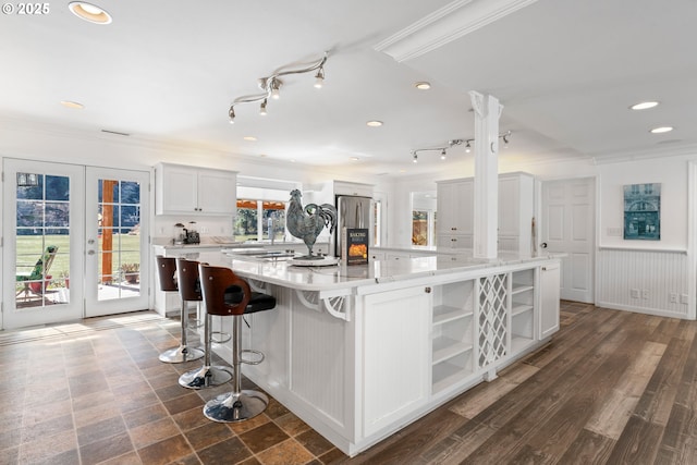 9202 Phey Ln, Florence, OR 97439 - kitchen with open shelves, light countertops, freestanding refrigerator, white cabinetry, and a large island