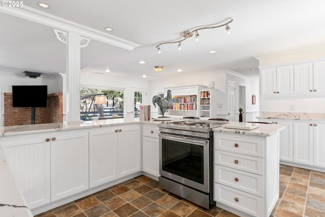 9202 Phey Ln, Florence, OR 97439 - kitchen featuring stone finish floor, stainless steel electric range oven, white cabinets, ornamental molding, and recessed lighting