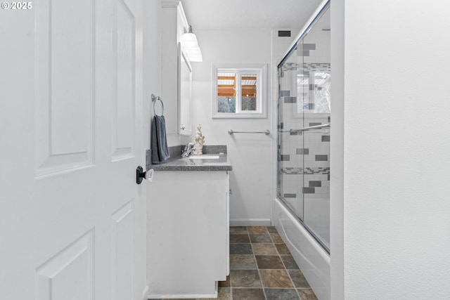 9202 Phey Ln, Florence, OR 97439 - full bathroom with stone finish flooring, combined bath / shower with glass door, and vanity