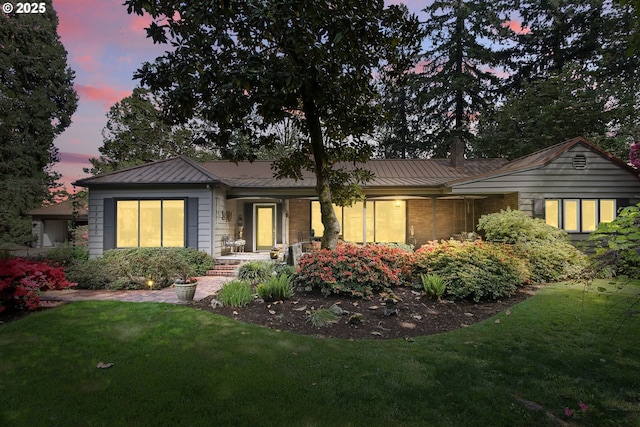 13720 SW Butner Rd, Beaverton, OR 97005 - view of front of property with a standing seam roof, a front yard, and metal roof