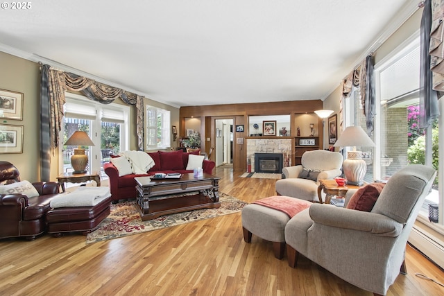 13720 SW Butner Rd, Beaverton, OR 97005 - living room featuring crown molding, baseboard heating, a stone fireplace, and wood finished floors