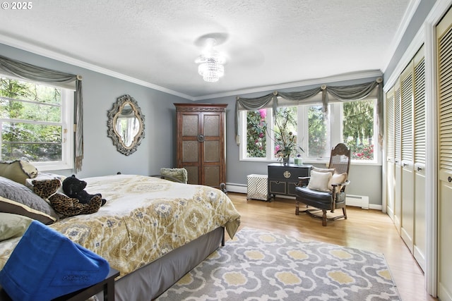 13720 SW Butner Rd, Beaverton, OR 97005 - bedroom with multiple windows, a baseboard heating unit, ornamental molding, light wood-style flooring, and a textured ceiling