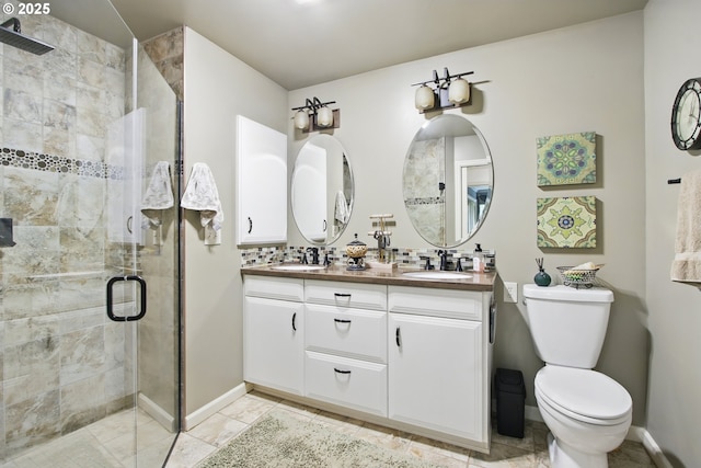 13720 SW Butner Rd, Beaverton, OR 97005 - full bathroom featuring a stall shower, double vanity, toilet, and baseboards