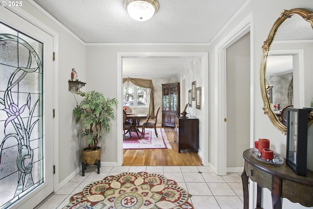 13720 SW Butner Rd, Beaverton, OR 97005 - entryway featuring light tile patterned floors, a textured ceiling, ornamental molding, and baseboards