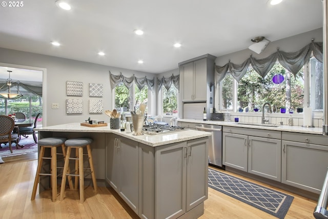 13720 SW Butner Rd, Beaverton, OR 97005 - kitchen with gray cabinets, stainless steel appliances, a kitchen island, healthy amount of natural light, and recessed lighting