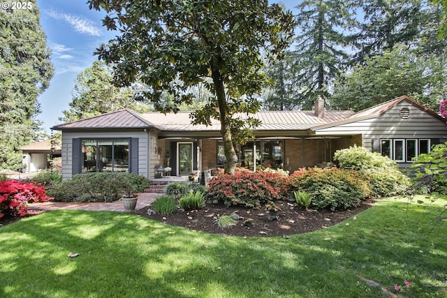 13720 SW Butner Rd, Beaverton, OR 97005 - rear view of house featuring a yard, a chimney, a standing seam roof, and metal roof