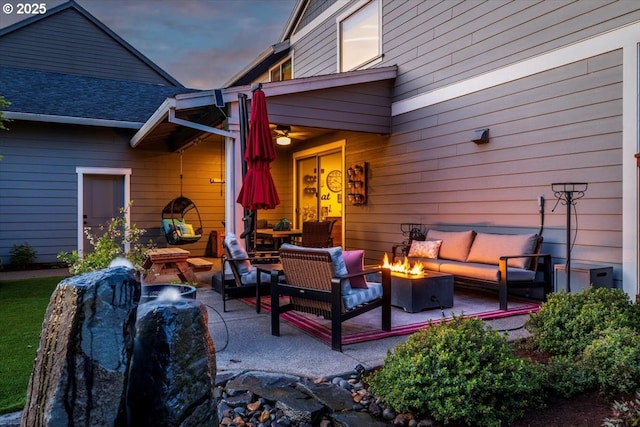 view of patio / terrace with an outdoor living space with a fire pit