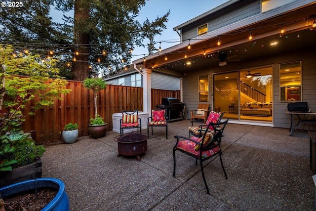 view of patio / terrace with fence, a ceiling fan, grilling area, and an outdoor fire pit