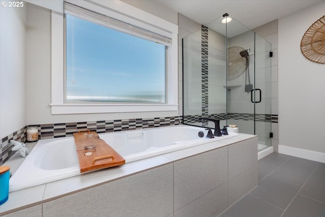 bathroom with a garden tub, tile patterned floors, and a stall shower