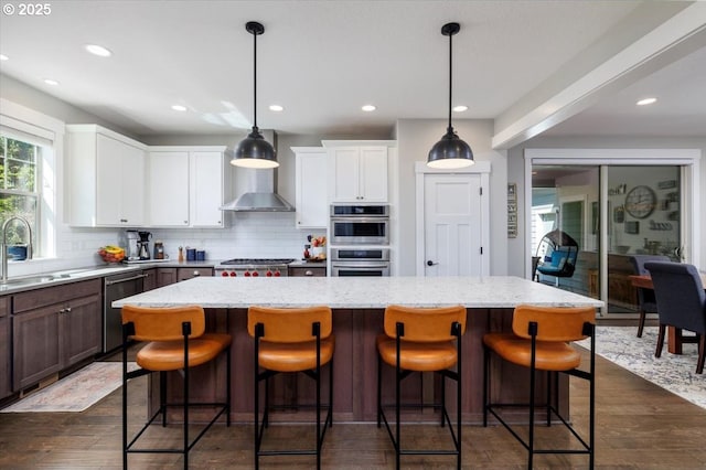 kitchen with recessed lighting, a sink, tasteful backsplash, and stainless steel appliances