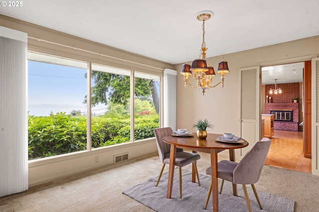 1228 11th St, Astoria, OR 97103 - dining space with a chandelier, light colored carpet, and a fireplace