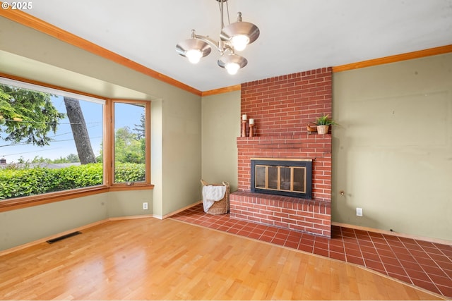 1228 11th St, Astoria, OR 97103 - unfurnished living room featuring wood finished floors, a fireplace, ornamental molding, and a chandelier