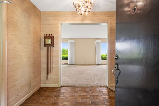 1228 11th St, Astoria, OR 97103 - carpeted foyer featuring baseboards and a chandelier