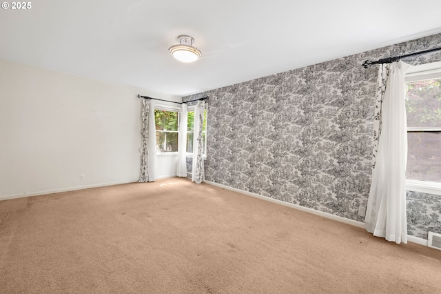 1228 11th St, Astoria, OR 97103 - carpeted empty room with wallpapered walls and plenty of natural light
