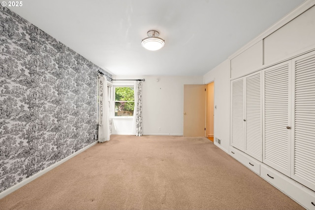 1228 11th St, Astoria, OR 97103 - unfurnished bedroom with carpet flooring, wallpapered walls, and a closet