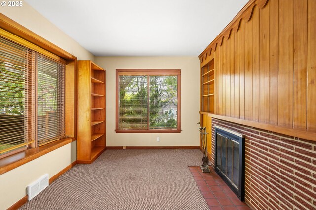 1228 11th St, Astoria, OR 97103 - unfurnished living room with dark carpet and a fireplace