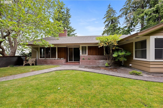 1228 11th St, Astoria, OR 97103 - view of front of house featuring a chimney, a front yard, and brick siding
