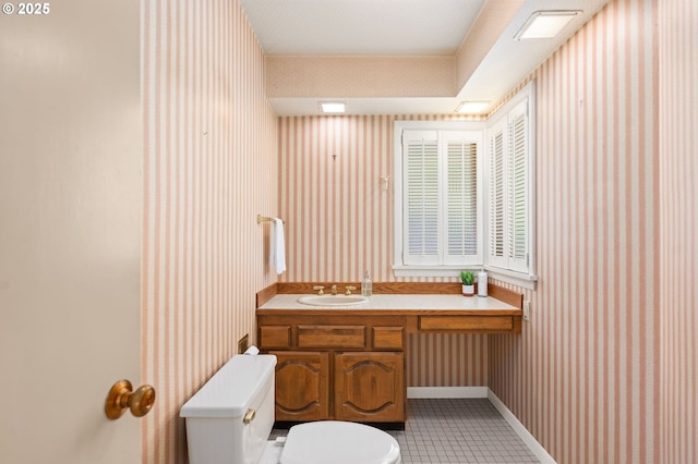 1228 11th St, Astoria, OR 97103 - half bath with wallpapered walls, vanity, and tile patterned flooring
